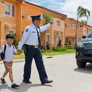 24 7 camella batangas security guard helping kid to cross streets